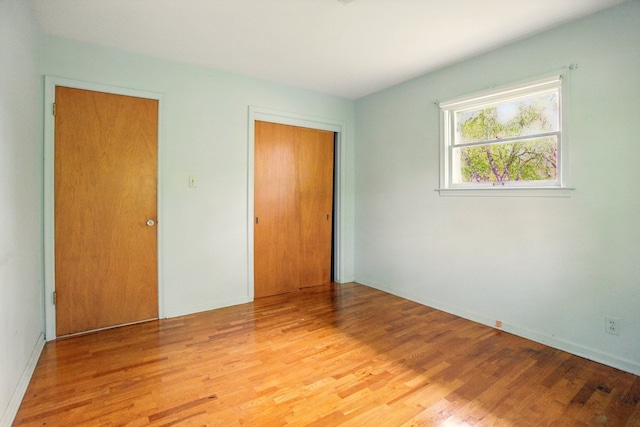 1469 Westwood Dr, Flint, MI 48532 - unfurnished bedroom featuring light wood-type flooring, a closet, and baseboards