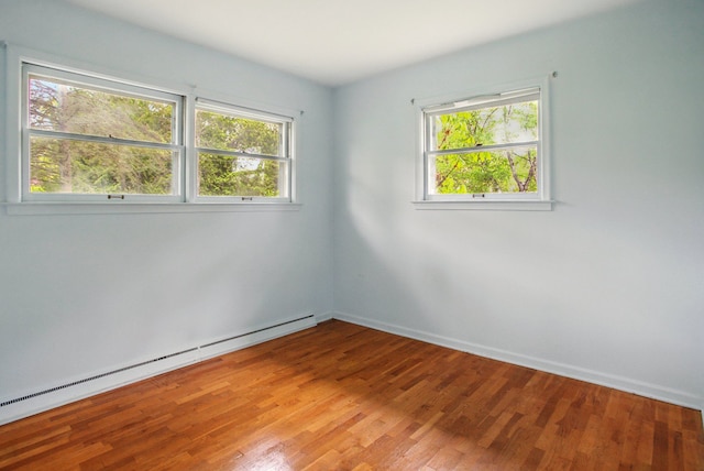 1469 Westwood Dr, Flint, MI 48532 - empty room featuring a baseboard radiator, healthy amount of natural light, light wood-style floors, and baseboards