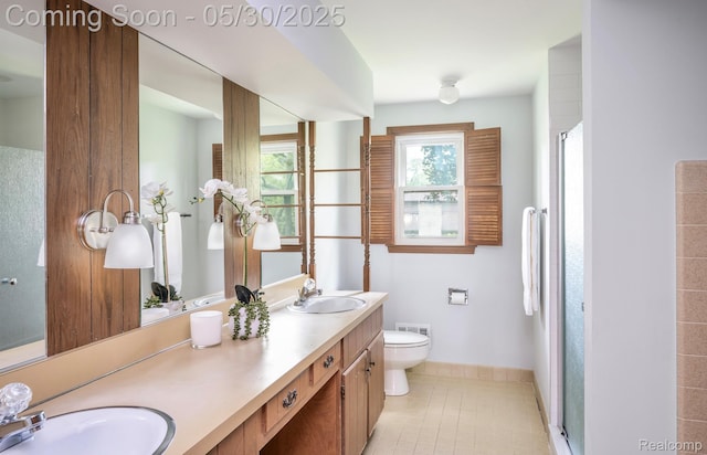 18851 Capitol Dr, Southfield, MI 48075 - bathroom featuring double vanity, toilet, baseboards, a stall shower, and tile patterned flooring
