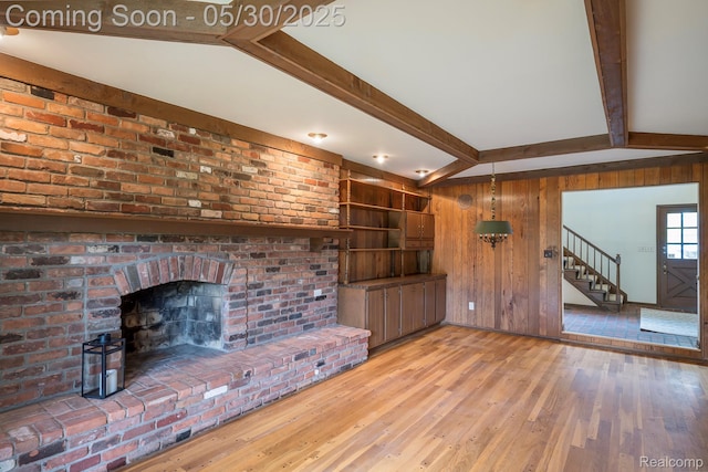18851 Capitol Dr, Southfield, MI 48075 - unfurnished living room with wooden walls, hardwood / wood-style flooring, and stairs