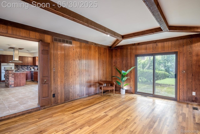 18851 Capitol Dr, Southfield, MI 48075 - spare room featuring wooden walls, beam ceiling, and light wood-style flooring