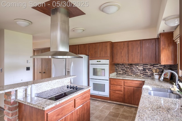 18851 Capitol Dr, Southfield, MI 48075 - kitchen with black electric stovetop, white double oven, island range hood, a sink, and a center island
