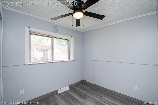 72 N Astor St, Pontiac, MI 48342 - unfurnished room with dark wood-style flooring, a textured ceiling, crown molding, ceiling fan, and wainscoting