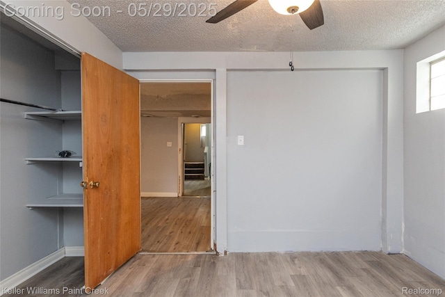 72 N Astor St, Pontiac, MI 48342 - unfurnished bedroom with a textured ceiling, wood finished floors, a ceiling fan, and baseboards