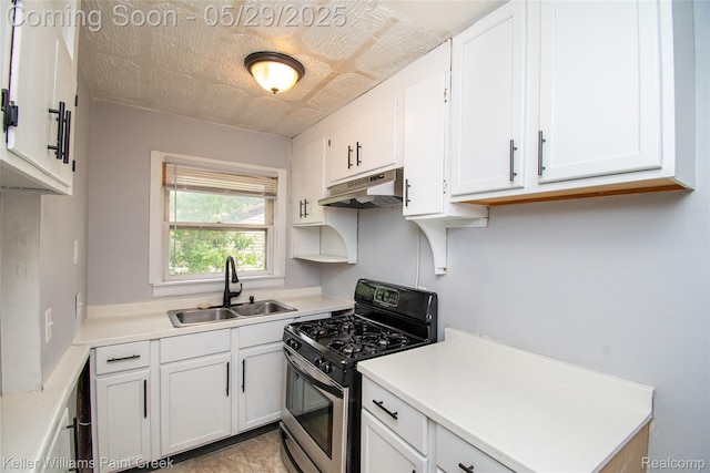 72 N Astor St, Pontiac, MI 48342 - kitchen with under cabinet range hood, a sink, stainless steel range with gas cooktop, white cabinets, and light countertops