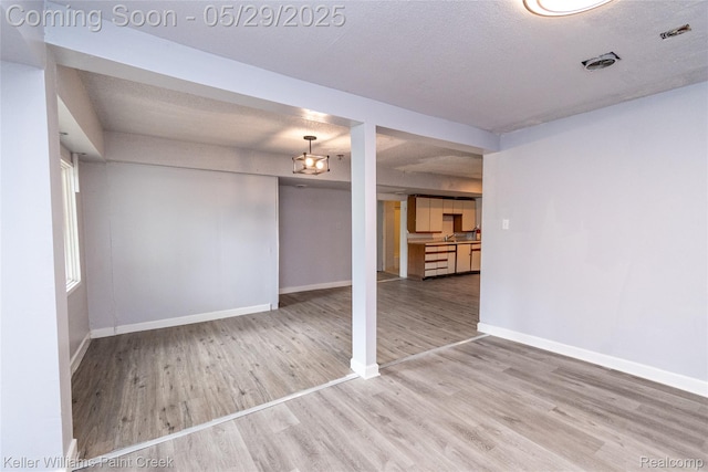 72 N Astor St, Pontiac, MI 48342 - unfurnished living room featuring wood finished floors and baseboards