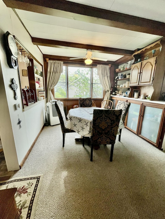 404 W Court St, Ludington, MI 49431 - dining space with light colored carpet, beam ceiling, and ceiling fan