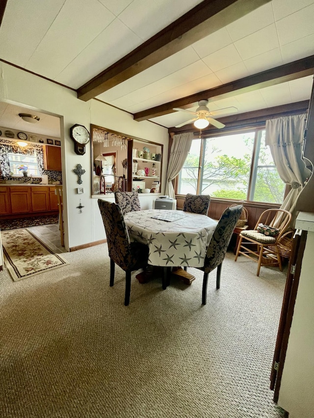 404 W Court St, Ludington, MI 49431 - dining space with light colored carpet, beam ceiling, and ceiling fan