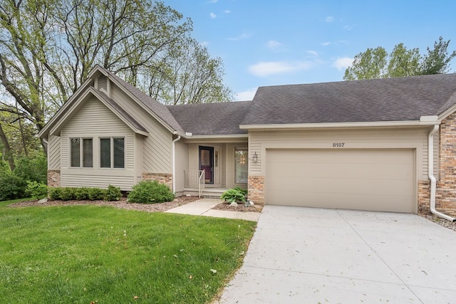 8187 Sawgrass Trl, Grand Blanc, MI 48439 - view of front facade with a garage, concrete driveway, a front lawn, roof with shingles, and brick siding