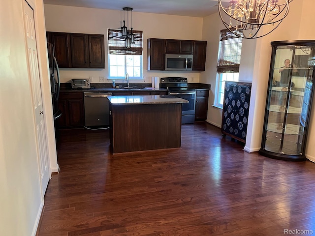 2065 Pinecroft Dr Unit 201, Canton, MI 48188 - kitchen featuring appliances with stainless steel finishes, a chandelier, dark countertops, and dark wood finished floors