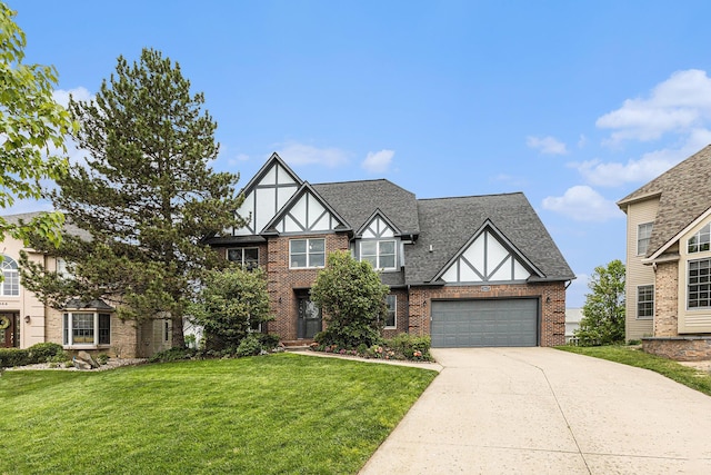 1817 High Pointe Ln, Ann Arbor, MI 48108 - english style home with driveway, brick siding, a front yard, roof with shingles, and an attached garage