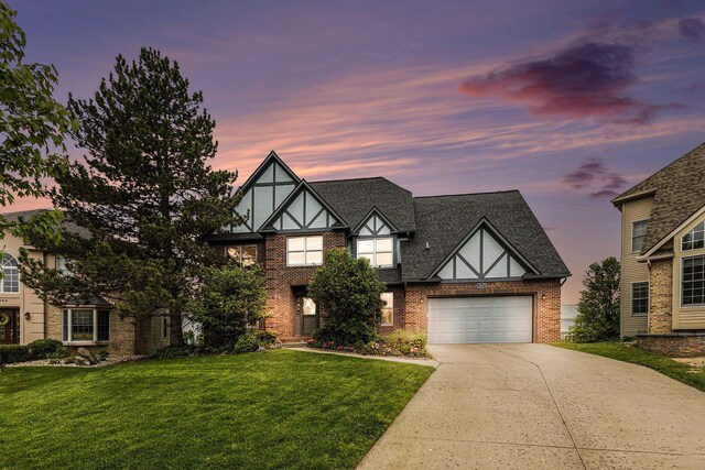 1817 High Pointe Ln, Ann Arbor, MI 48108 - tudor-style house with driveway, brick siding, a front lawn, and roof with shingles