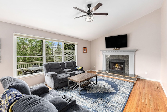 1817 High Pointe Ln, Ann Arbor, MI 48108 - living room featuring ceiling fan, wood finished floors, baseboards, lofted ceiling, and a high end fireplace