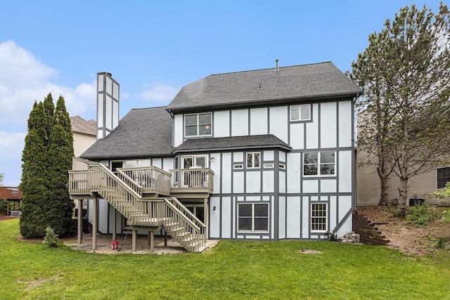 1817 High Pointe Ln, Ann Arbor, MI 48108 - back of property featuring stairs, a wooden deck, a lawn, a chimney, and roof with shingles