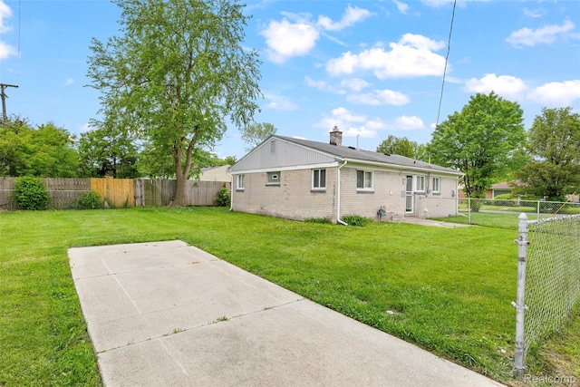 3907 Bayhan St, Inkster, MI 48141 - back of house with a patio, brick siding, and a chimney