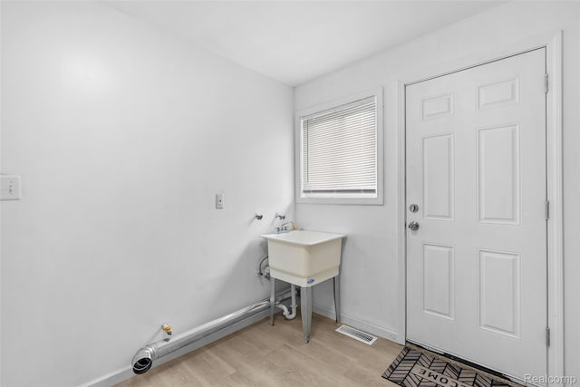 3907 Bayhan St, Inkster, MI 48141 - laundry area featuring light wood-style floors and baseboards