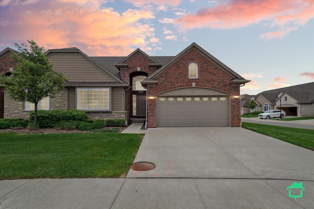 5104 Hawkseye Trce, Warren, MI 48092 - view of front of home with concrete driveway, a lawn, stone siding, and brick siding