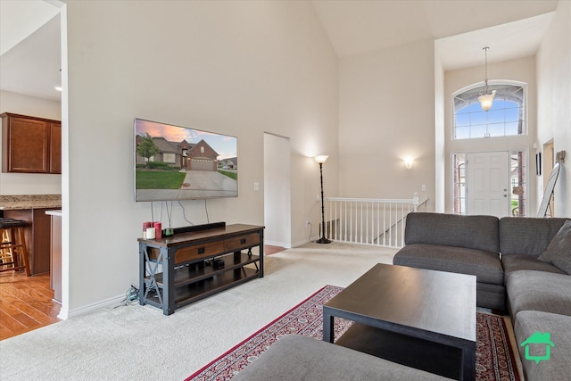 5104 Hawkseye Trce, Warren, MI 48092 - living room featuring high vaulted ceiling, light colored carpet, and baseboards