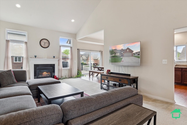 5104 Hawkseye Trce, Warren, MI 48092 - living room featuring healthy amount of natural light, baseboards, high vaulted ceiling, a glass covered fireplace, and recessed lighting