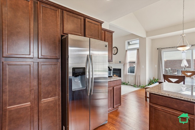 5104 Hawkseye Trce, Warren, MI 48092 - kitchen featuring stainless steel refrigerator with ice dispenser, wood finished floors, light stone countertops, decorative light fixtures, and vaulted ceiling
