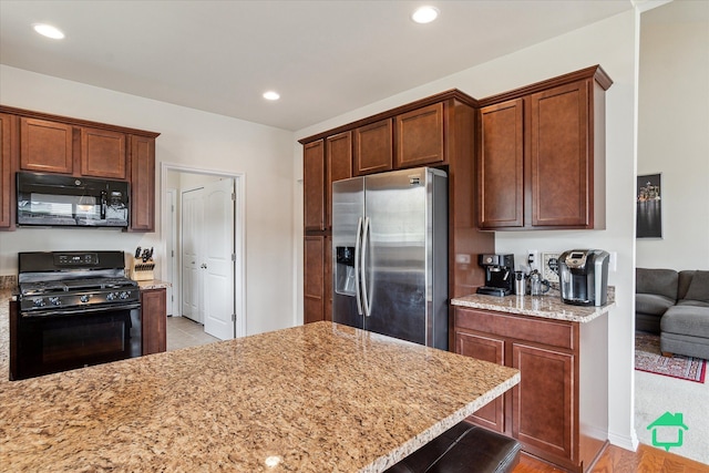 5104 Hawkseye Trce, Warren, MI 48092 - kitchen with black appliances, light stone counters, and recessed lighting