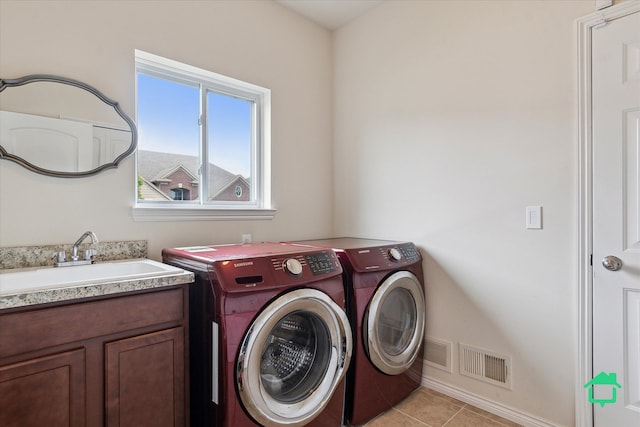 5104 Hawkseye Trce, Warren, MI 48092 - washroom with a sink, washing machine and dryer, light tile patterned flooring, and baseboards