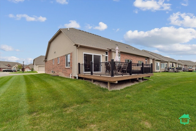 5104 Hawkseye Trce, Warren, MI 48092 - rear view of property featuring a wooden deck, brick siding, a lawn, and a residential view