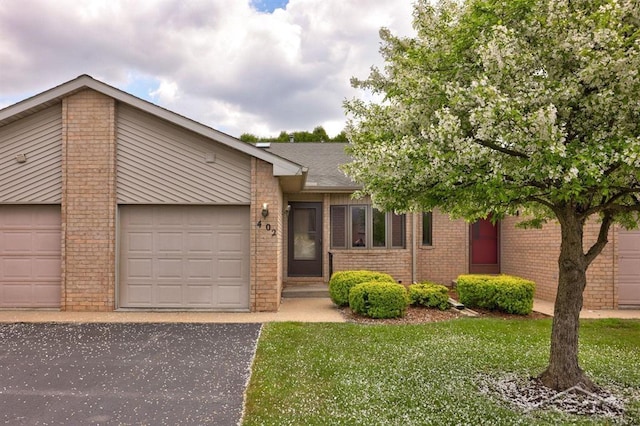 402 Morningside Dr, Midland, MI 48640 - view of front of house featuring brick siding, an attached garage, asphalt driveway, and a front lawn