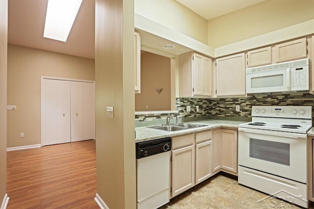 402 Morningside Dr, Midland, MI 48640 - kitchen with white appliances, a sink, tasteful backsplash, light countertops, and light wood-style flooring