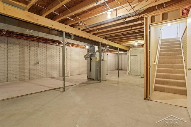 402 Morningside Dr, Midland, MI 48640 - unfinished below grade area with stairway, heating unit, and gas water heater