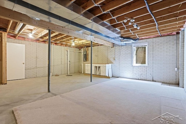 402 Morningside Dr, Midland, MI 48640 - unfinished basement featuring brick wall and electric panel
