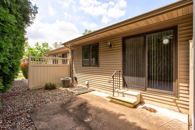 402 Morningside Dr, Midland, MI 48640 - view of exterior entry featuring a patio area and central AC unit