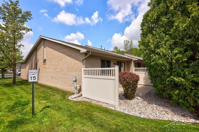 402 Morningside Dr, Midland, MI 48640 - view of property exterior featuring brick siding and a yard