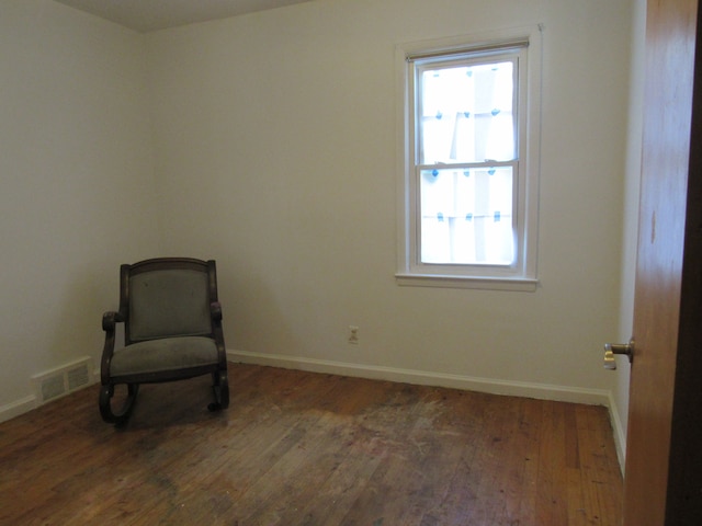 unfurnished room with baseboards and wood finished floors