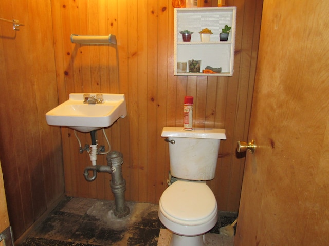 half bathroom with wooden walls and toilet