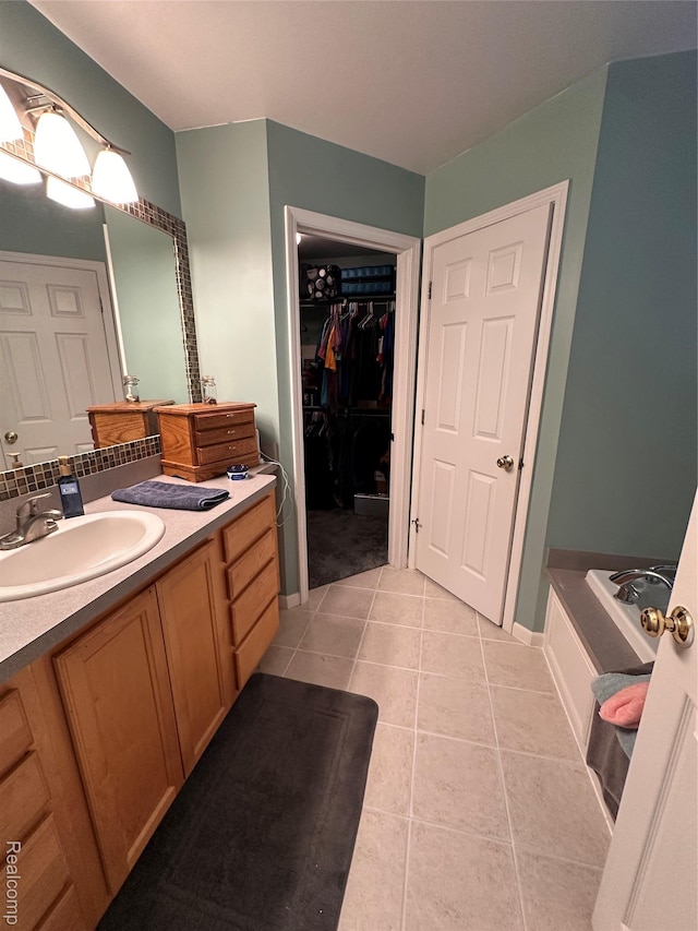790 Vivian Ln, Oxford, MI 48371 - bathroom featuring vanity, a bath, tile patterned flooring, and a spacious closet
