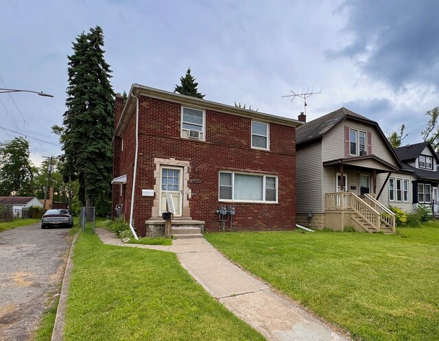 4057 High St, Ecorse, MI 48229 - view of front of home with brick siding, a chimney, a front yard, and cooling unit