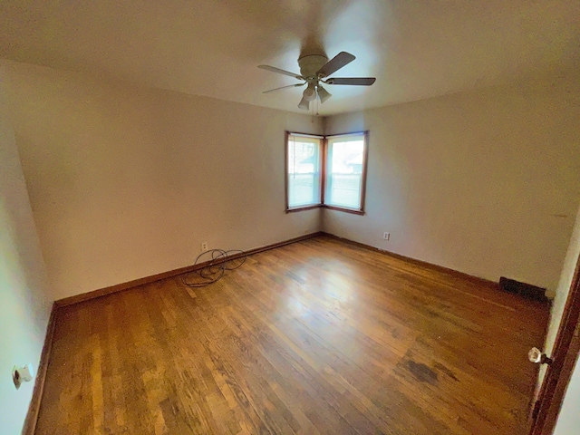 4057 High St, Ecorse, MI 48229 - empty room with light wood finished floors, a ceiling fan, and baseboards