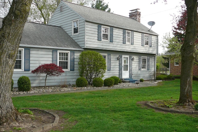 466 Salem Dr, Jonesville, MI 49250 - colonial home with a chimney, a front lawn, and roof with shingles