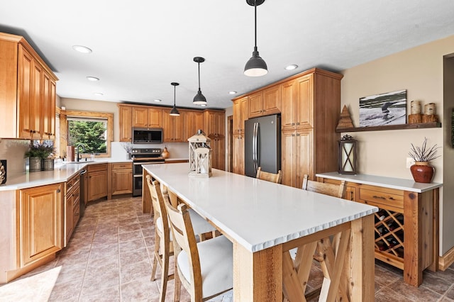 9861 W Doyle Dr, Mecosta, MI 49332 - kitchen featuring appliances with stainless steel finishes, a center island, a sink, recessed lighting, and light countertops
