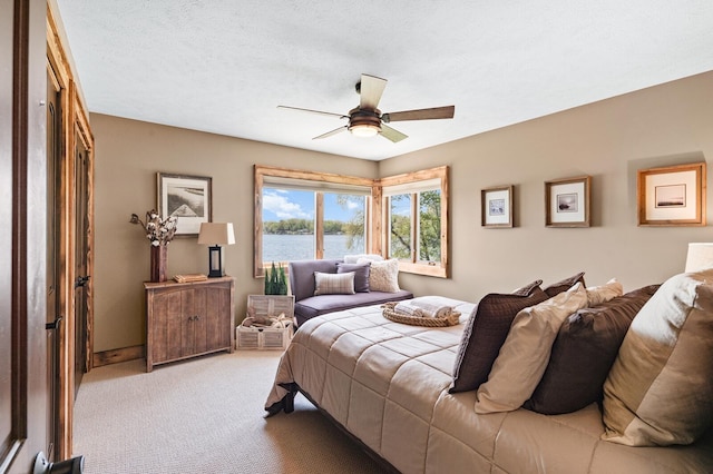 9861 W Doyle Dr, Mecosta, MI 49332 - bedroom featuring light carpet, a water view, and a ceiling fan