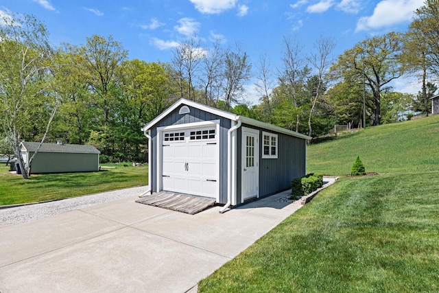 9861 W Doyle Dr, Mecosta, MI 49332 - detached garage with driveway and view of wooded area