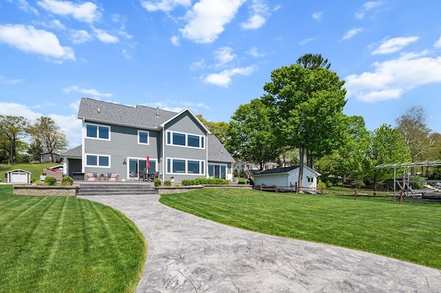 9861 W Doyle Dr, Mecosta, MI 49332 - rear view of property with a yard and a shingled roof