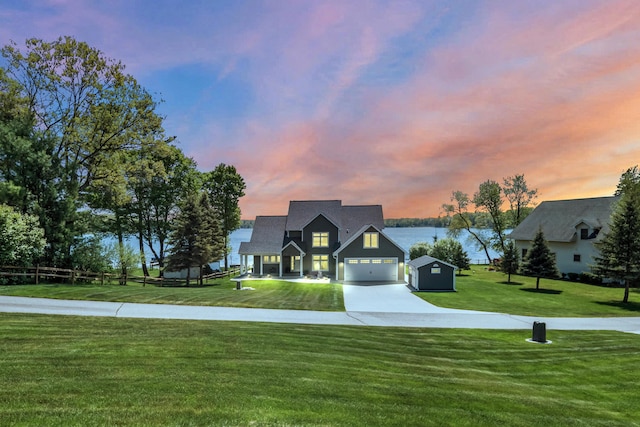 9861 W Doyle Dr, Mecosta, MI 49332 - view of front of home featuring concrete driveway, a front yard, and a water view