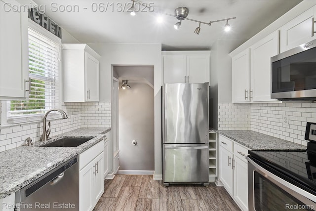 1976 Bacon Ave, Berkley, MI 48072 - kitchen featuring appliances with stainless steel finishes, white cabinets, backsplash, and light stone counters