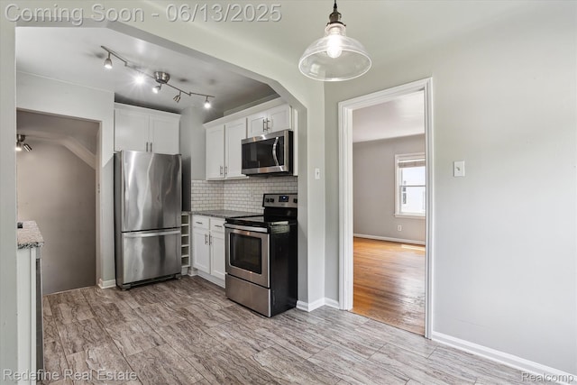 1976 Bacon Ave, Berkley, MI 48072 - kitchen featuring stainless steel appliances, white cabinetry, backsplash, light wood-style flooring, and decorative light fixtures