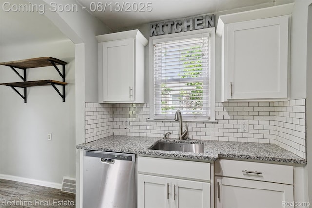 1976 Bacon Ave, Berkley, MI 48072 - kitchen featuring stainless steel dishwasher, white cabinetry, decorative backsplash, and light stone countertops