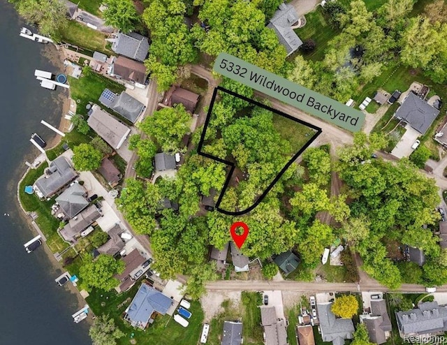 5332 Wildwood Dr, Howell, MI 48843 - aerial perspective of suburban area with a nearby body of water