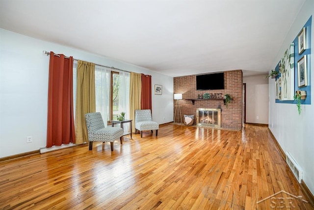 4215 Washington St, Midland, MI 48642 - living area featuring light wood-style floors, a fireplace, and baseboards