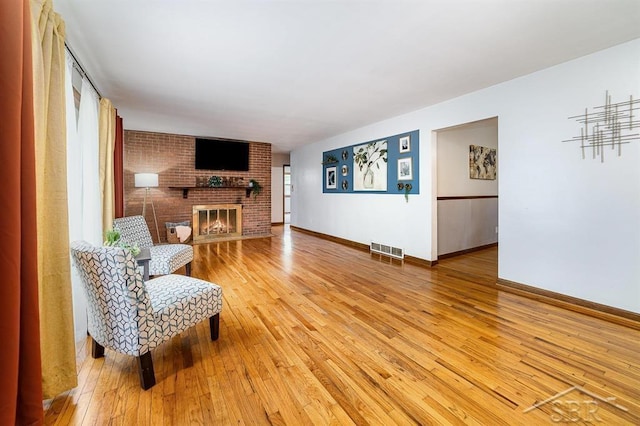 4215 Washington St, Midland, MI 48642 - living room featuring light wood-style floors, baseboards, and a fireplace